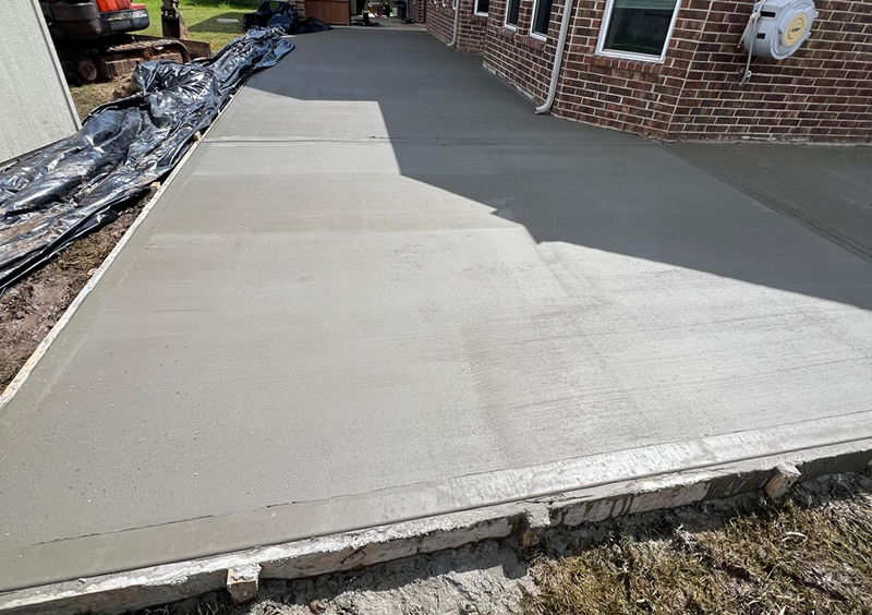 New concrete slab curing in sunlight.