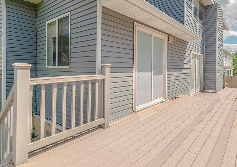 Light brown deck with white railing