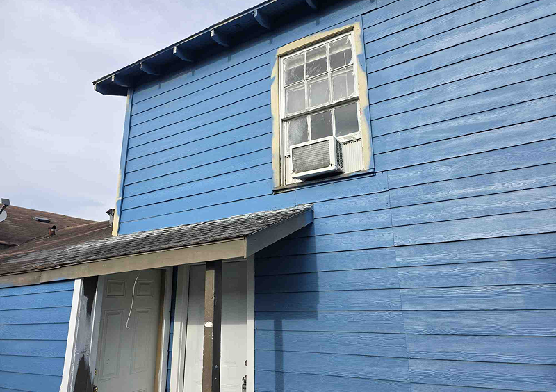 Blue house with window air conditioner