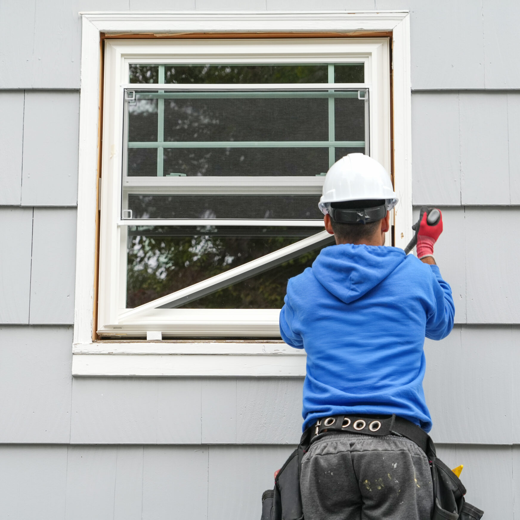 Construction worker fixing house window