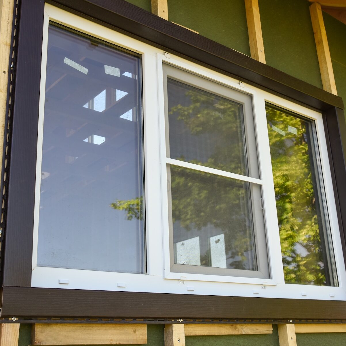 Double-pane window on green wall