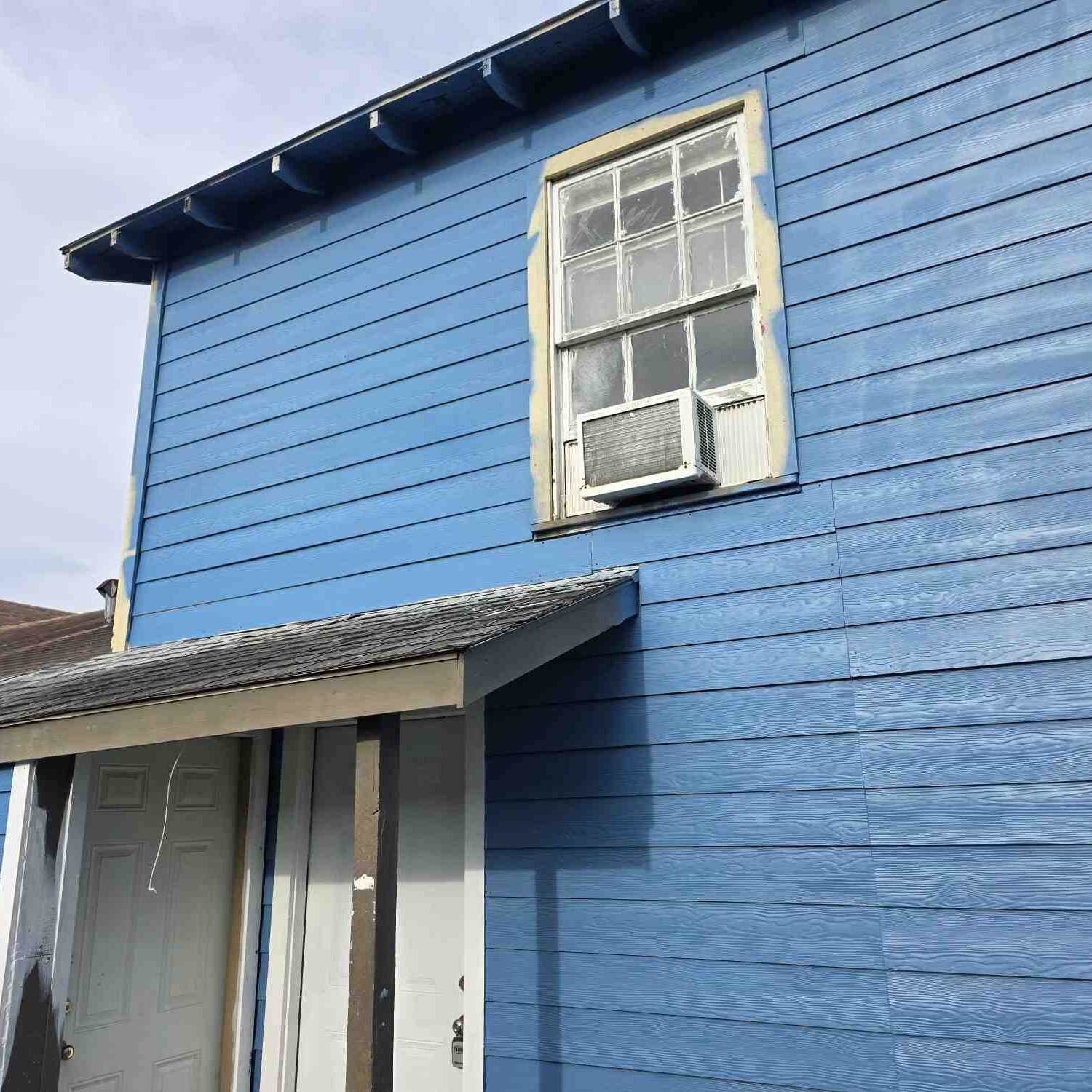 Wooden blue siding and window unit
