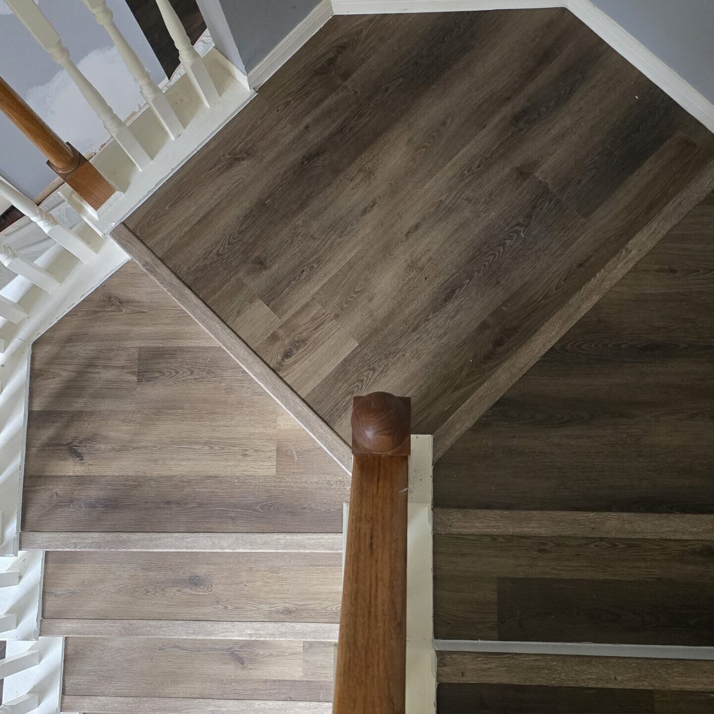 Wooden staircase with gray walls