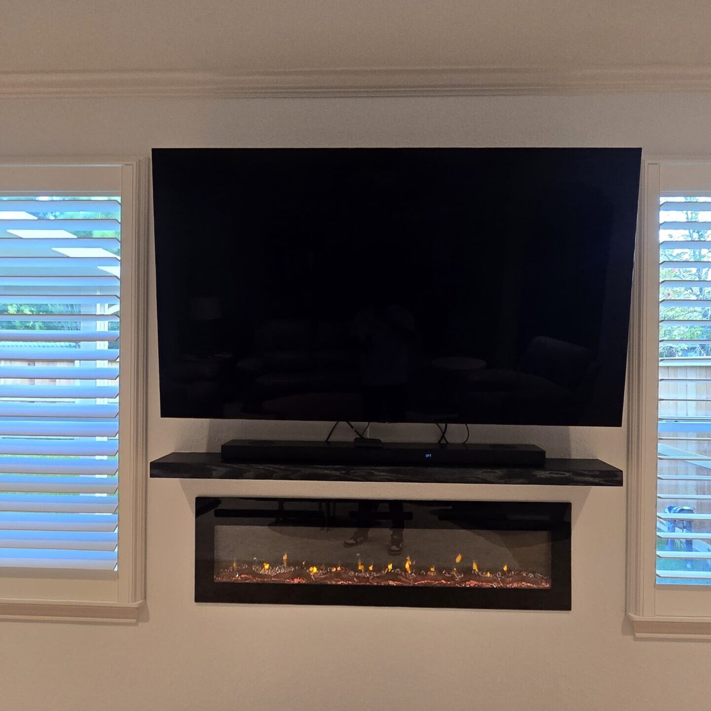 TV above decorative fireplace