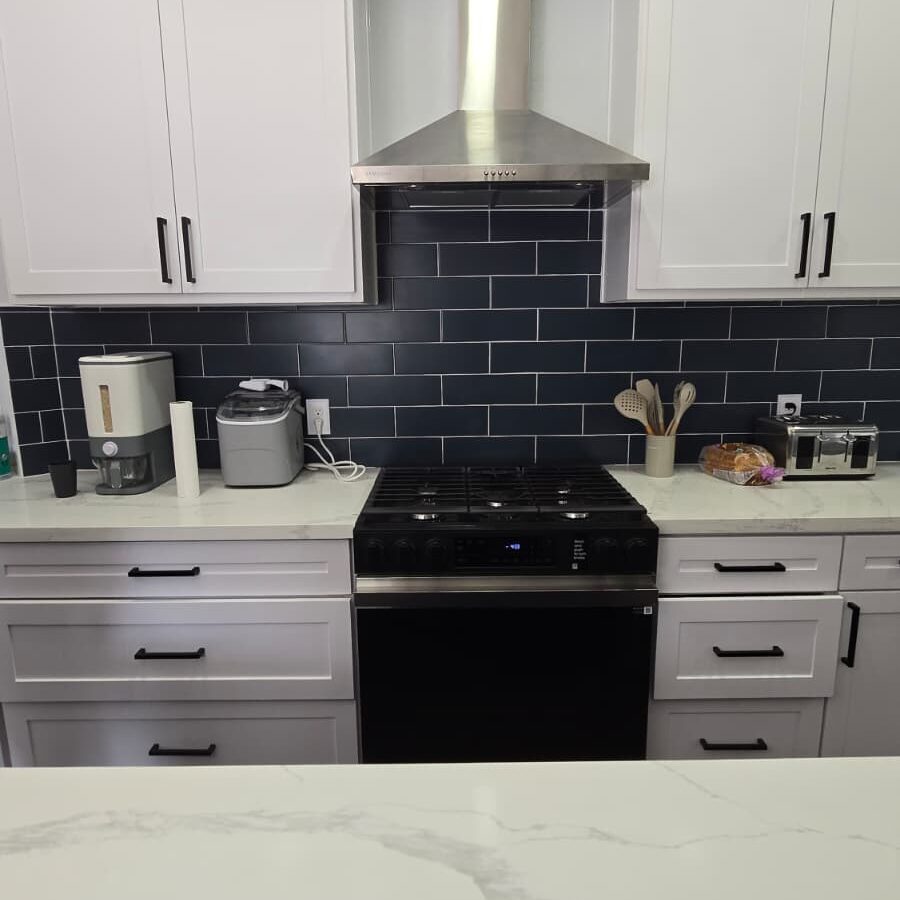 White cabinets and stainless steel range hood